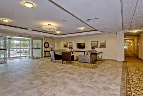 an empty lobby with a table and chairs at Candlewood Suites Burlington by IHG in Burlington