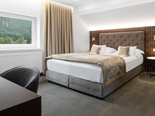 a hotel room with a bed and a window at Garni Hotel Cirman in Ljubljana