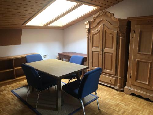 a dining room with a table and chairs and a skylight at Haus Wenger Mountain View & Swimming Pool in Kaprun