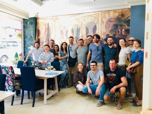 a group of people posing for a picture in a room at Arabesque Hotel in Amman