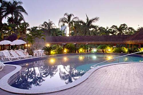 a swimming pool with lights in a resort at HOT SPRINGS HOTEL Caldas Novas-FLAT VIP in Caldas Novas
