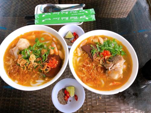 a table with three bowls of food on a table at Nhat Minh Hotel in La Gi