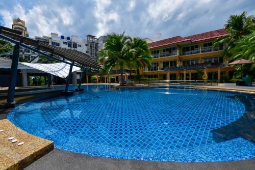 a large blue swimming pool in front of a building at R-Mar Resort and Spa Patong, Phuket in Patong Beach