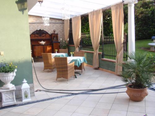 a gazebo with a table and chairs on a patio at Villa-Angelina in Langenzersdorf