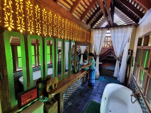 a woman is standing in a train bathroom at BaanBooLoo Village in Chiang Mai