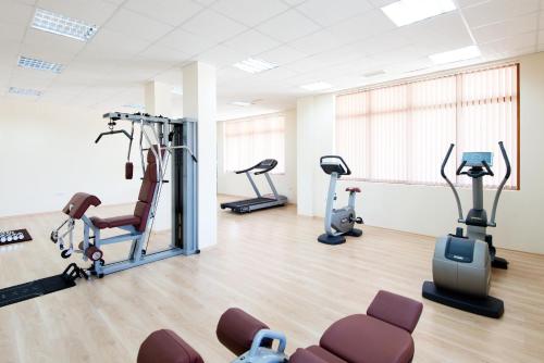 a gym with treadmills and ellipticals in a room at Sunrise All Suites Resort- All Inclusive in Obzor
