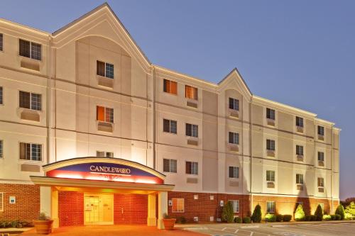 a large white building with a sign in front of it at Candlewood Suites Clarksville by IHG in Clarksville