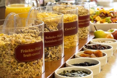 a table topped with glasses of different types of food at Hotel Löwengarten in Speyer