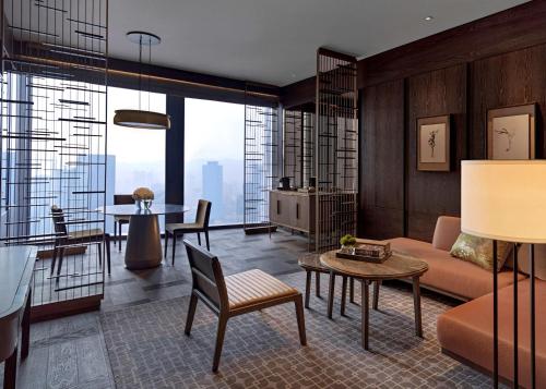 a living room with a couch and a table at Park Hyatt Shenzhen in Shenzhen