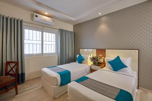 Katil atau katil-katil dalam bilik di Regenta Inn Indiranagar by Royal Orchid Hotels