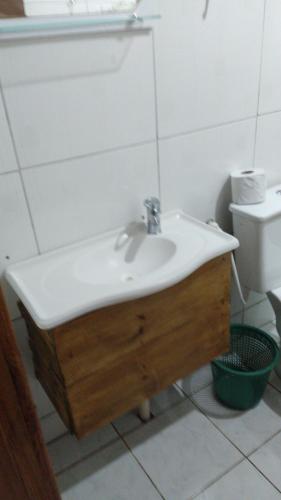 a bathroom with a sink and a toilet at Pousada avenida in Urubici