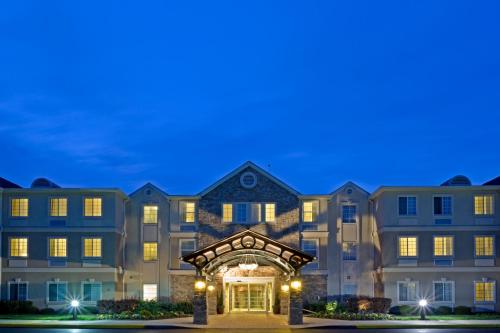 a large apartment building with an entrance at night at Staybridge Suites-Philadelphia/Mount Laurel by IHG in Mount Laurel