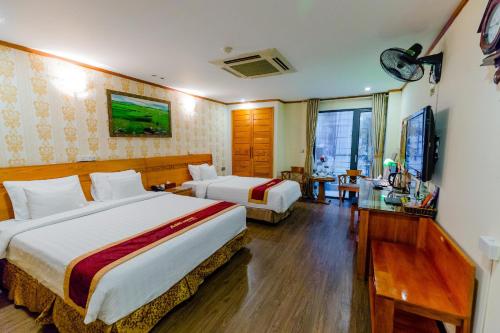 a hotel room with two beds and a television at A25 Hotel - 45 Phan Chu Trinh in Hanoi