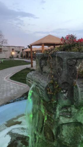 a water fountain in the middle of a yard at Rawaat Ghaym in Taif