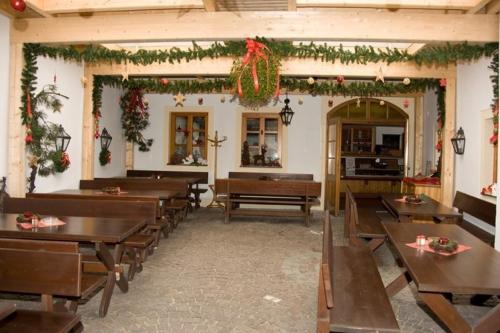 a dining room with wooden tables and christmas decorations at Gasthof Ludl in Groß-Enzersdorf