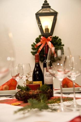 a table with wine glasses and a bottle of wine at Gasthof Ludl in Groß-Enzersdorf