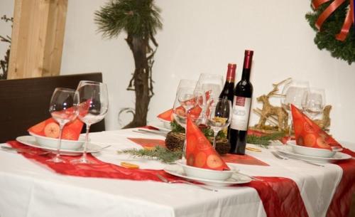 a table topped with wine glasses and wine bottles at Gasthof Ludl in Groß-Enzersdorf