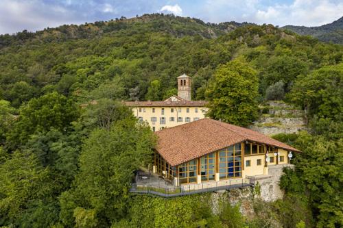 a large building in the middle of a mountain at Certosa 1515 in Avigliana