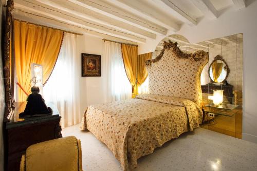 a bedroom with a bed and a window at Casa Fortuny Luxury Apartment in Venice