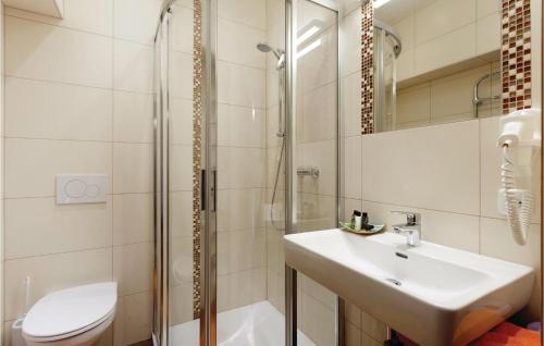 a bathroom with a sink and a shower and a toilet at Beautiful Apartment In Kartitsch With 3 Bedrooms in Kartitsch