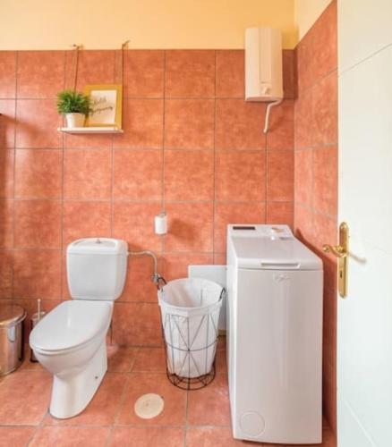 a bathroom with a toilet and a sink at Villa Casa Del Sol with private pool in Sounio