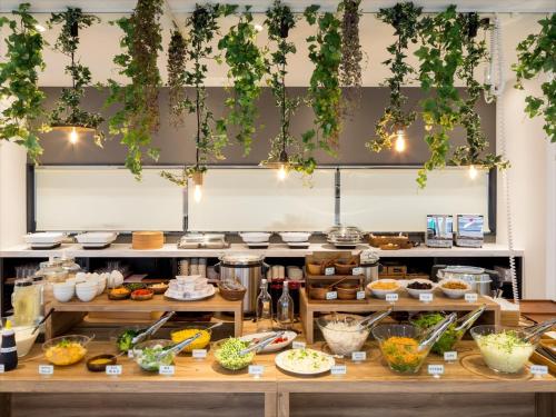 a kitchen with lots of food on display at Green Rich Hotel Tottori Ekimae (Artificial hot spring Futamata Yunohana) in Tottori