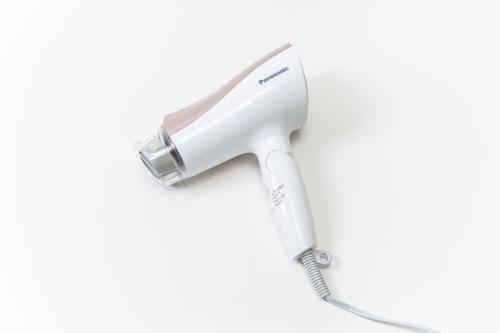 a white hair dryer on a white background at HOTEL AMANEK Kyoto Kawaramachi Gojo in Kyoto
