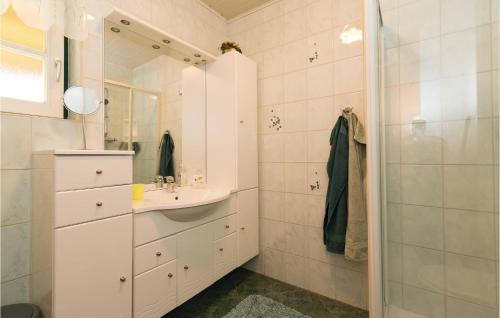 a white bathroom with a sink and a shower at Kellerstöckl Winten in Winten