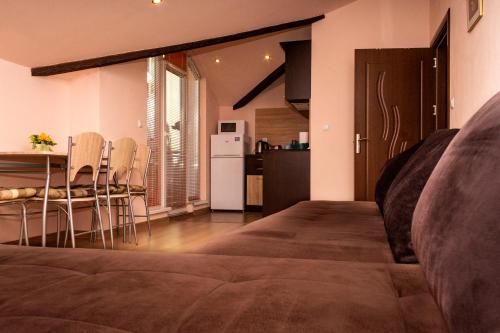 a living room with a couch and a kitchen at New Star Residence in Burgas City