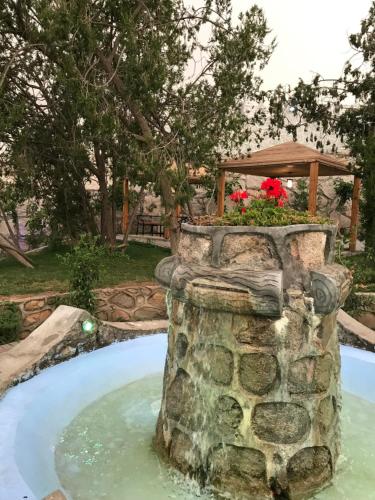 a water feature in a yard with a fountain at Rawaat Ghaym in Taif