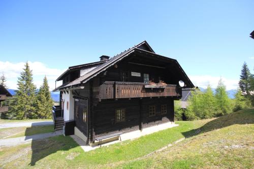 an old wooden house on a hill in a field at Sonnleitn 29 in Sonnenalpe Nassfeld