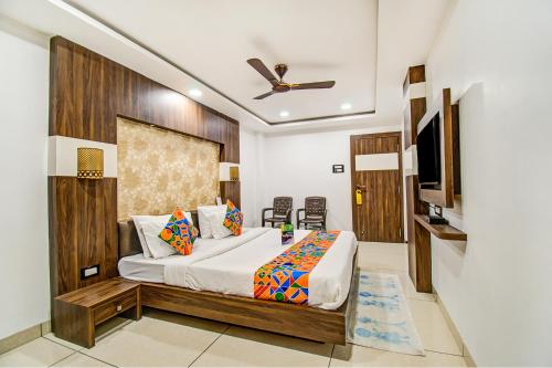 - une chambre avec un lit et une télévision à écran plat dans l'établissement FabHotel Rajnandani Residency Bhawarkua, à Indore