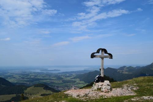 a cross on the top of a mountain at Chiemsee Chalet in Frasdorf