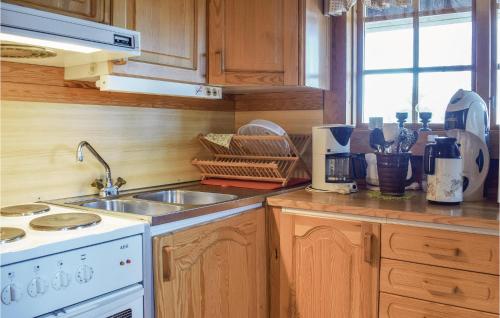 a kitchen with a sink and a stove top oven at Two-Bedroom Holiday Home In Hogsby in Högsby