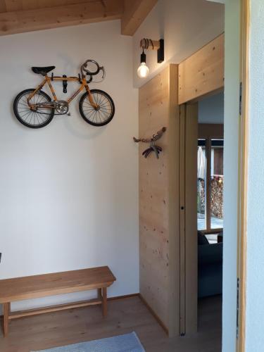 a bike hanging on the wall of a room at CANOLS#32 in Valbella