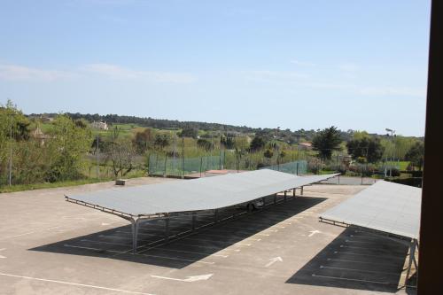 a large tennis court with a large tennis court at Ca La Maria in Tordera