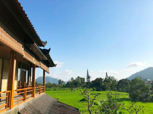 a building with a view of a green field at Noka Homestay in Sidemen