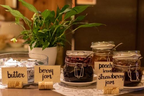 a table with jars of jam and a plant at Castello Di Meleto in Gaiole in Chianti