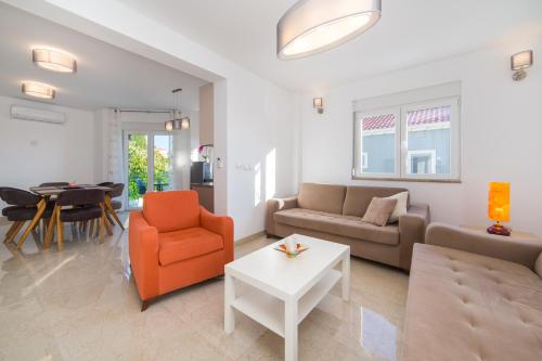 a living room with a couch and a table at Apartments Zvonik in Brist