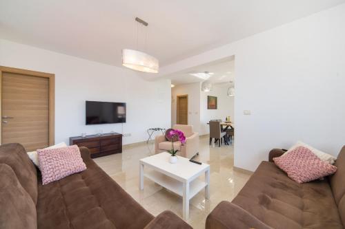 a living room with a couch and a table at Apartments Zvonik in Brist