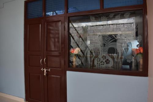 a wooden cabinet with a fireplace in a room at Malakar Home stay in Port Blair