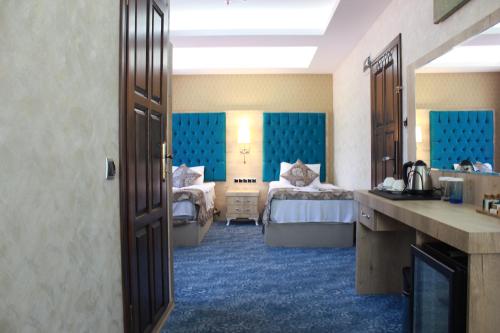a hotel room with two beds and a bathroom at Ayder Hasimoglu Hotel in Ayder Yaylasi