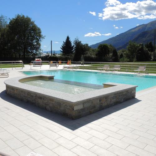 a swimming pool with a fountain in the middle at Residence Villa Paradiso in Gravedona