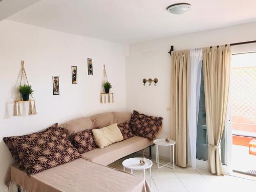 a living room with a couch and a window at Blue Ocean in Santa Maria
