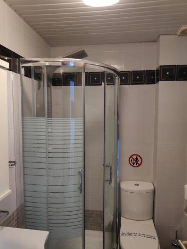 a bathroom with a toilet and a glass shower at Hilltop in Hanioti