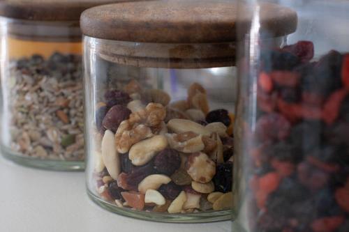 three glass jars filled with nuts and dried fruits at Hotel Motel 2000 in Trezzano sul Naviglio