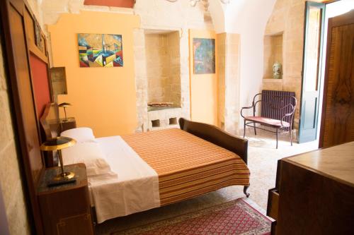 a small bedroom with a bed and a chair at B&B Malennio in Lecce