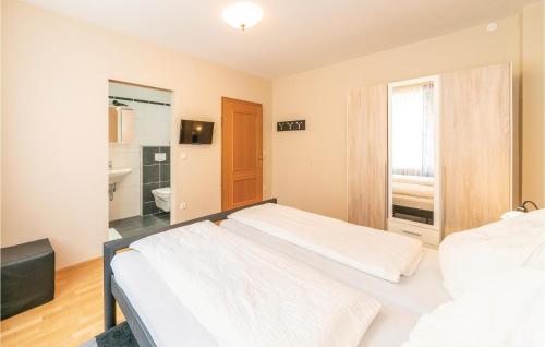 a bedroom with two beds and a bathroom at Ferienhaus Mit Panoramablick in Eisenberg an der Pinka