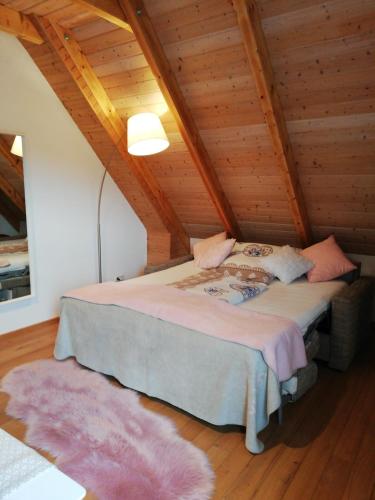 a bedroom with a large bed in a attic at Sweet Home Suite in Hallerndorf