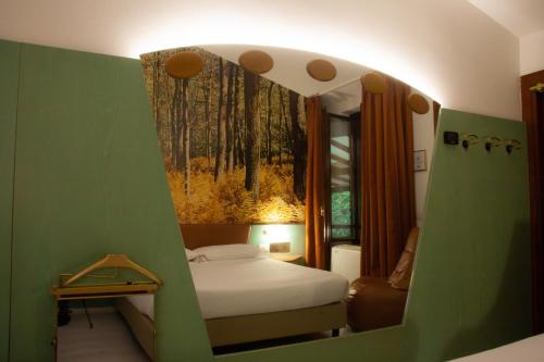 a small bedroom with a bed and a window at Hotel Motel 2000 in Trezzano sul Naviglio